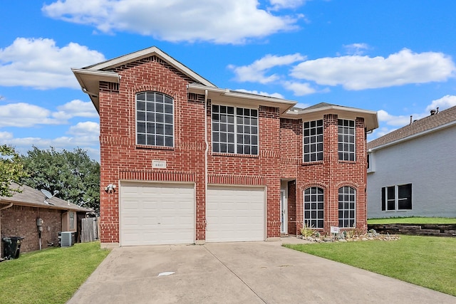 view of front of home featuring cooling unit, a garage, and a front yard