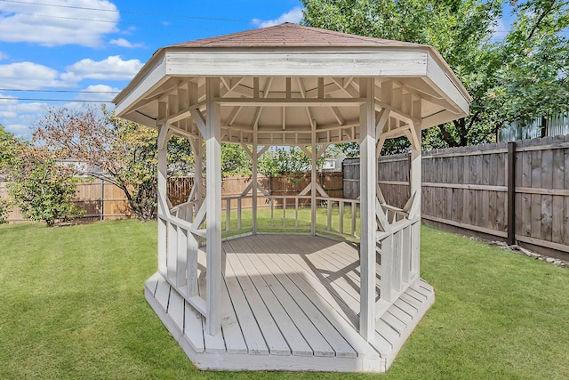 deck featuring a gazebo and a yard