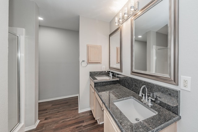 bathroom with wood-type flooring, vanity, and walk in shower