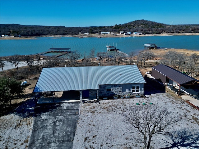 birds eye view of property with a water and mountain view