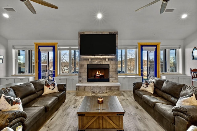 living room with ceiling fan, a healthy amount of sunlight, and light wood-type flooring