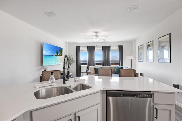 kitchen with white cabinetry, dishwasher, sink, ceiling fan, and kitchen peninsula