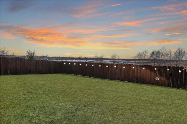 view of yard at dusk