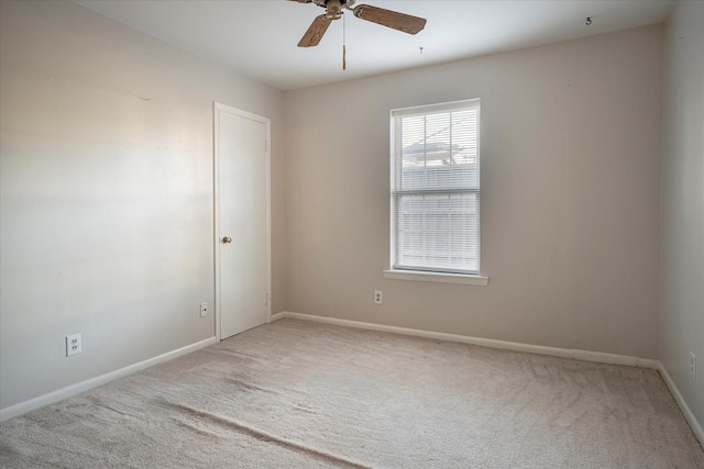 unfurnished room featuring ceiling fan and carpet flooring