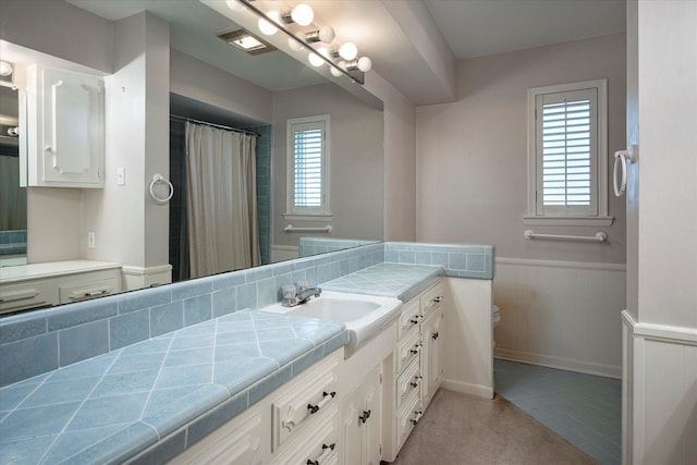 bathroom with vanity, tile patterned flooring, and toilet