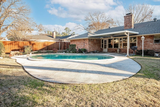 view of swimming pool with area for grilling, a lawn, and a patio area