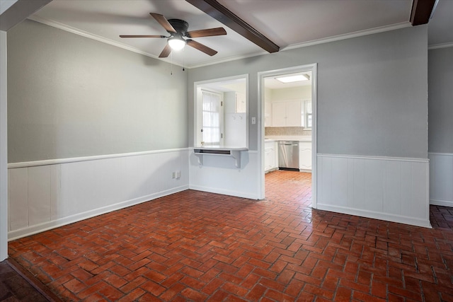 unfurnished room featuring beam ceiling, ornamental molding, and ceiling fan