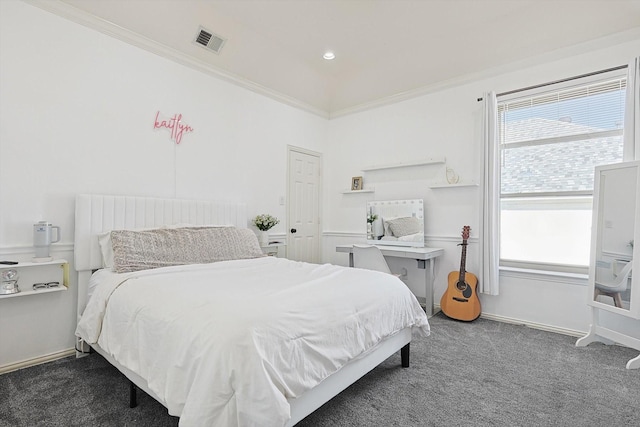 bedroom with crown molding and dark colored carpet