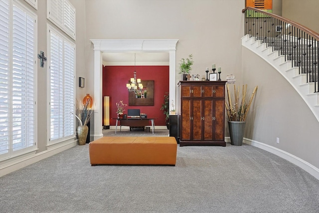 living area featuring a notable chandelier, a high ceiling, and carpet