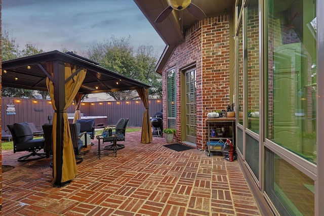 view of patio / terrace with a gazebo, ceiling fan, and area for grilling