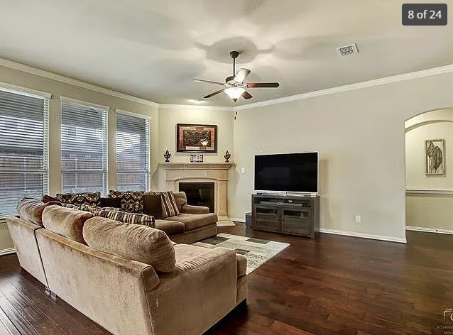 living room with crown molding, ceiling fan, and dark hardwood / wood-style flooring