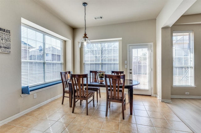 dining space featuring light tile patterned floors