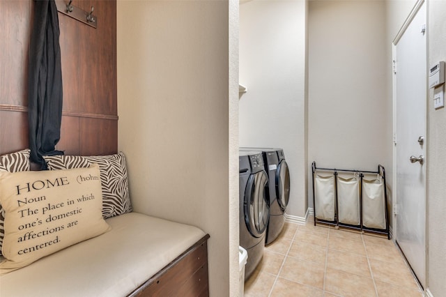 laundry area featuring separate washer and dryer and light tile patterned floors