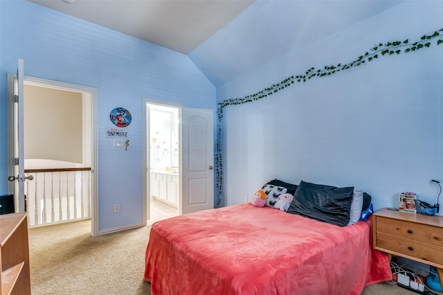 carpeted bedroom featuring vaulted ceiling and ensuite bathroom