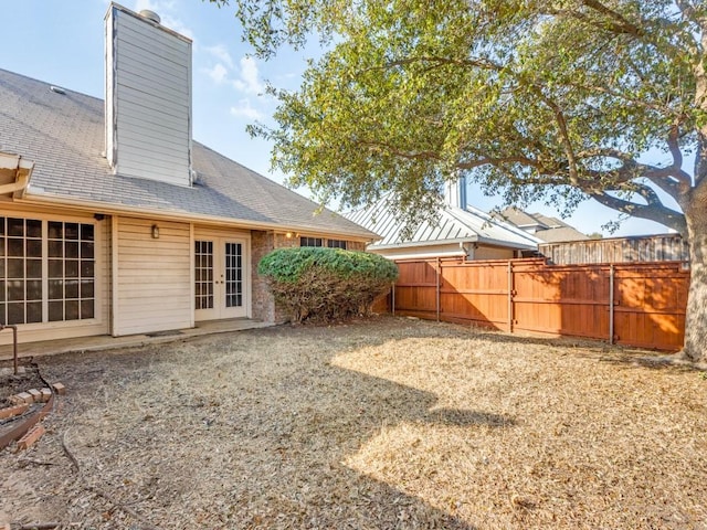 view of yard with french doors