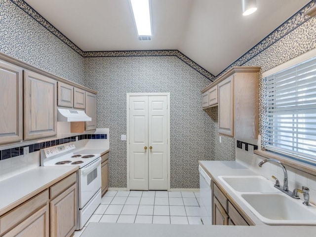 kitchen featuring light brown cabinetry, sink, vaulted ceiling, light tile patterned floors, and white appliances