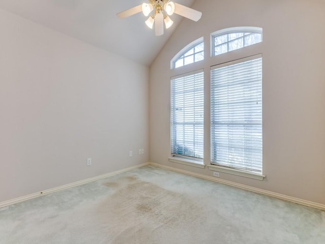 carpeted spare room with vaulted ceiling and ceiling fan