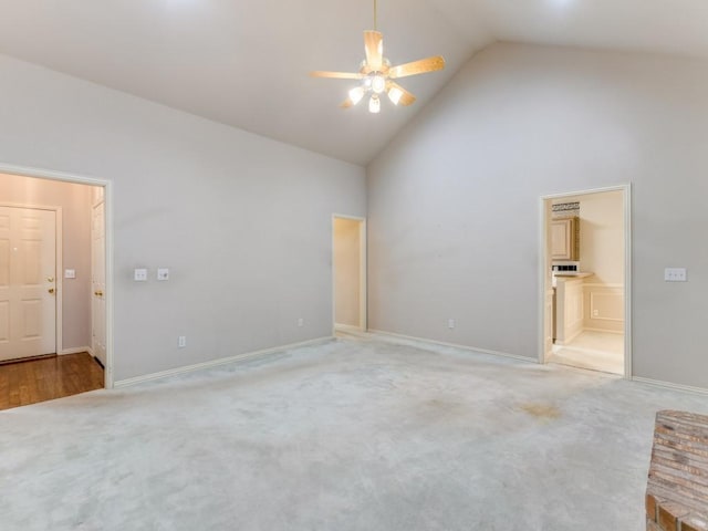 carpeted empty room featuring ceiling fan and high vaulted ceiling