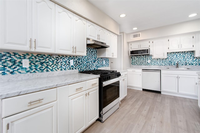 kitchen with sink, white cabinets, dishwashing machine, light hardwood / wood-style floors, and gas range oven