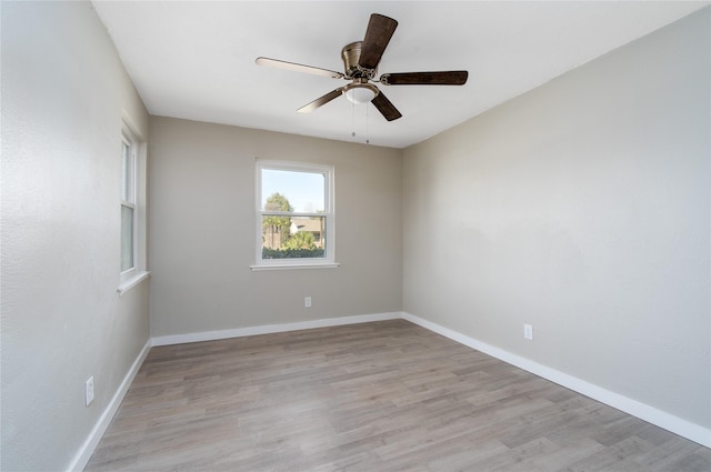 spare room with ceiling fan and light wood-type flooring