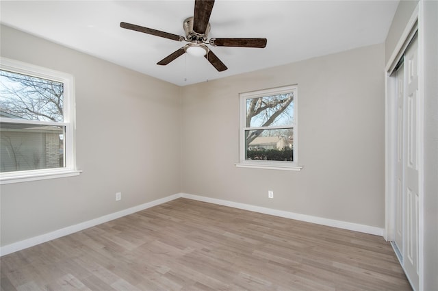 unfurnished bedroom featuring a closet, ceiling fan, and light wood-type flooring