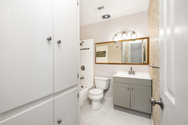 full bathroom with vanity, tiled shower / bath combo, tile patterned floors, and toilet