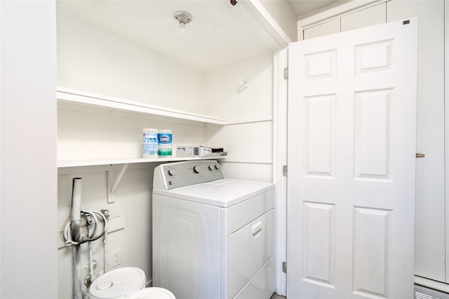 clothes washing area featuring washer / dryer