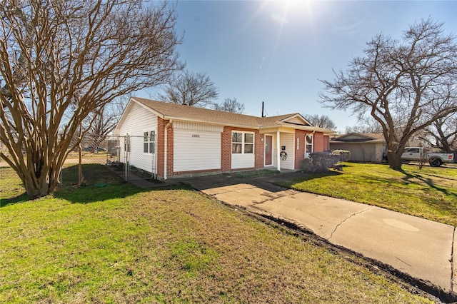 ranch-style home featuring a garage and a front lawn