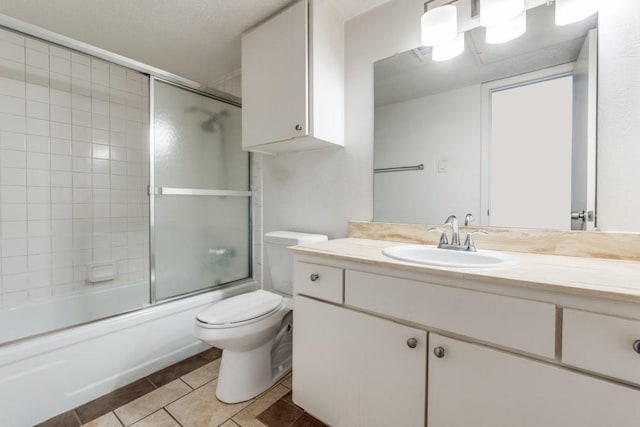 full bathroom featuring tile patterned flooring, bath / shower combo with glass door, vanity, and toilet