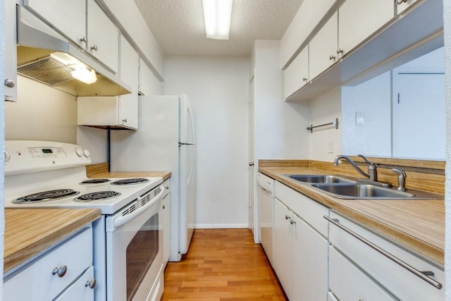 kitchen featuring sink, white cabinetry, a textured ceiling, white appliances, and light hardwood / wood-style floors