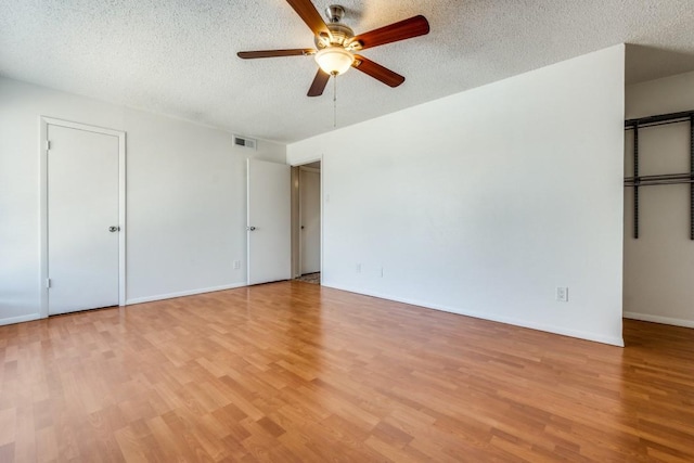 unfurnished bedroom with ceiling fan, light hardwood / wood-style floors, and a textured ceiling