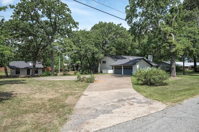 view of front of property with a garage and a front yard