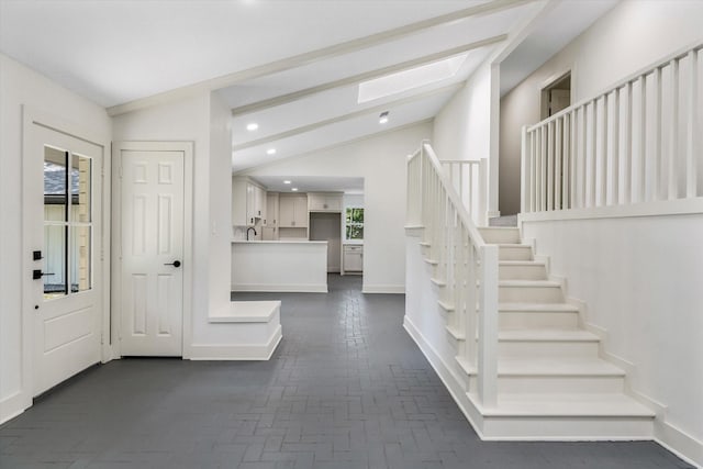 foyer featuring vaulted ceiling