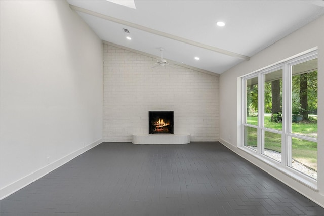 unfurnished living room featuring lofted ceiling with beams, a brick fireplace, and ceiling fan