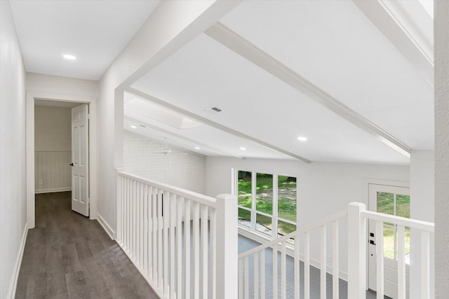 hall featuring dark wood-type flooring and beamed ceiling