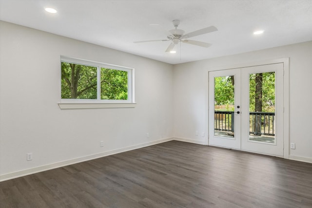 spare room with french doors, ceiling fan, and dark wood-type flooring