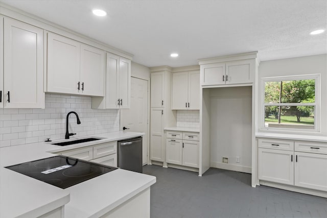 kitchen featuring sink, backsplash, dishwasher, black electric stovetop, and white cabinets