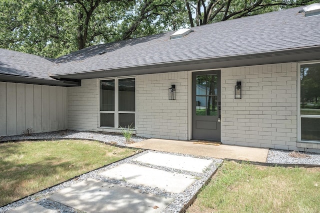 entrance to property with a yard