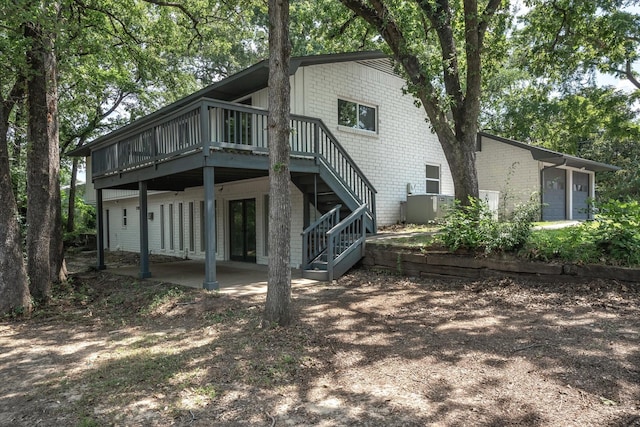 back of house with a deck