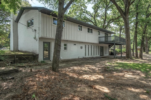 rear view of house with a wooden deck