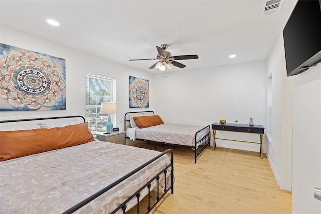 bedroom with light hardwood / wood-style floors and ceiling fan