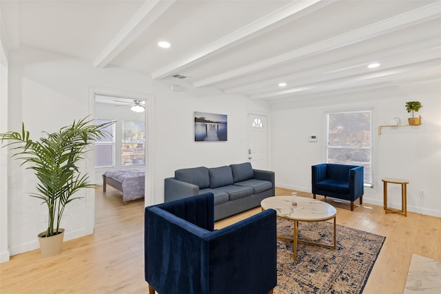 living room with beam ceiling, light hardwood / wood-style flooring, and ceiling fan