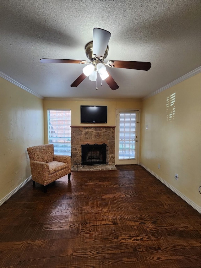 unfurnished living room featuring crown molding, dark wood-type flooring, a fireplace, and a healthy amount of sunlight