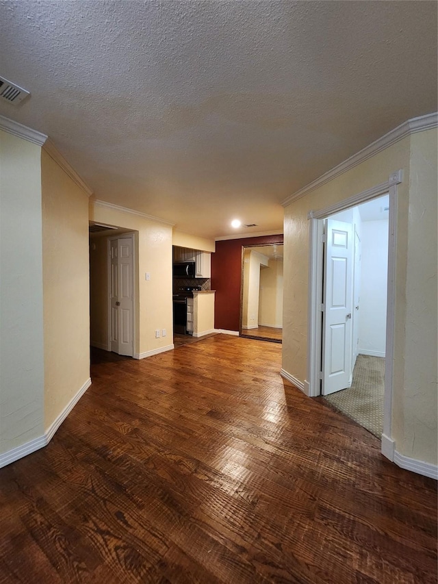 unfurnished living room featuring crown molding, dark hardwood / wood-style floors, and a textured ceiling