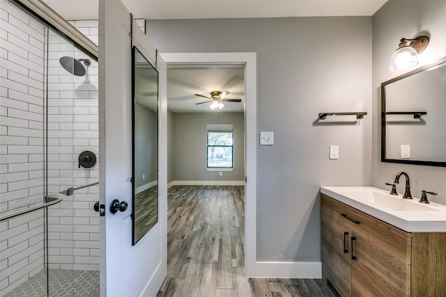 bathroom featuring hardwood / wood-style flooring, vanity, ceiling fan, and walk in shower