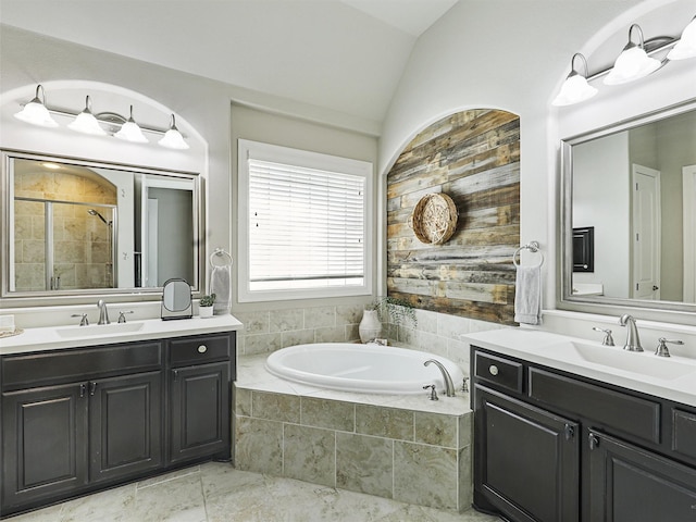 bathroom featuring vanity, vaulted ceiling, and plus walk in shower