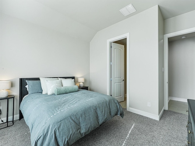 bedroom with vaulted ceiling and light carpet