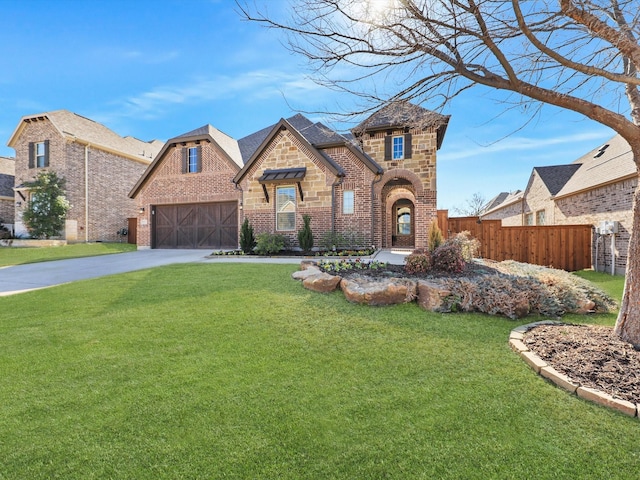 english style home with a garage and a front yard