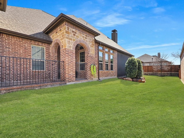 rear view of house with a lawn