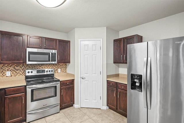 kitchen with decorative backsplash, stainless steel appliances, and light countertops